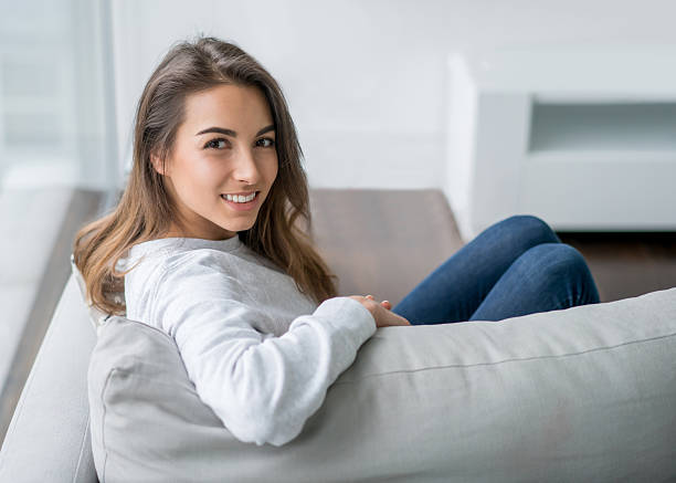 istock Woman relaxing at home sitting on the sofa 516077654