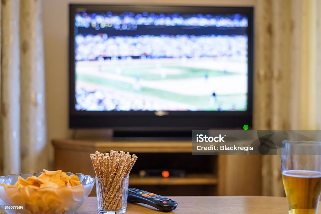 Television, TV watching (baseball match) with snacks and alcohol Television, TV watching (baseball match) with snacks and alcohol lying on table - stock photo Television Set Stock Photo