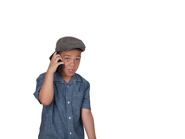 Mixed race boy with cellular phone stock photo