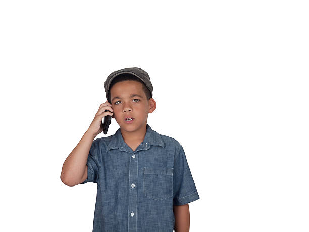 Mixed race boy with cellular phone stock photo