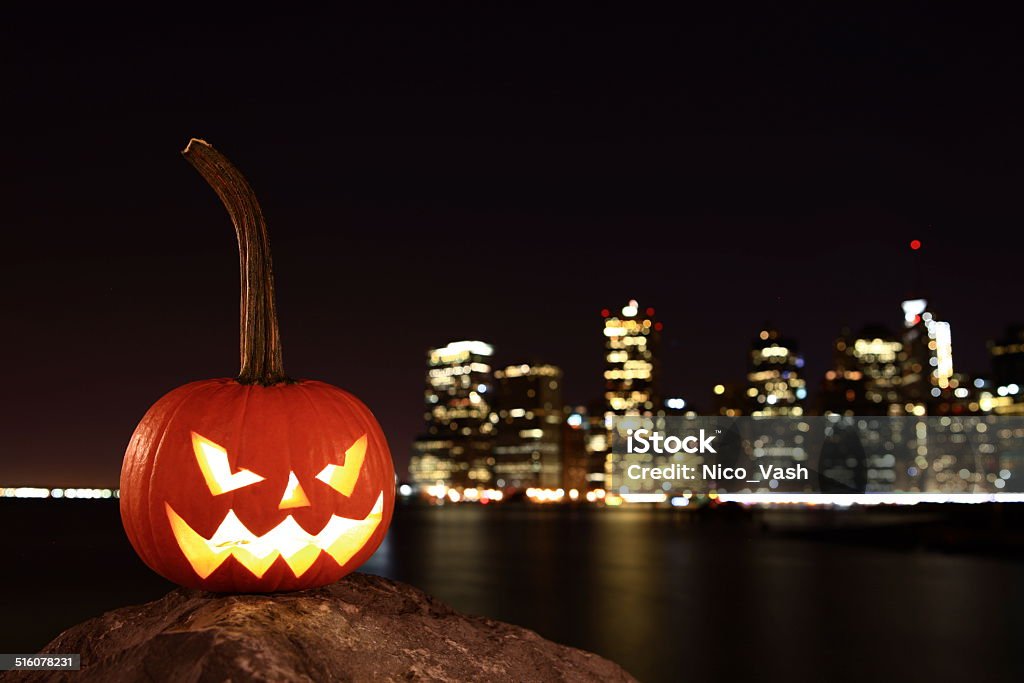Symbol of Halloween Scary pumpkin, symbol of Halloween, waiting for a celebrate on the shores of Brooklyn, against Manhattan Island, New York, United States Pumpkin Stock Photo