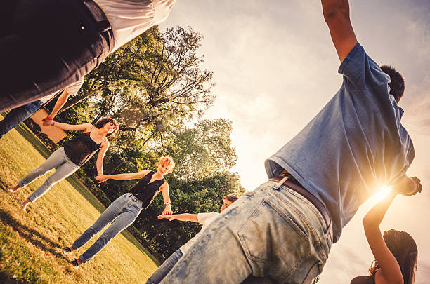 istock Friends holding hands in the park 516078615