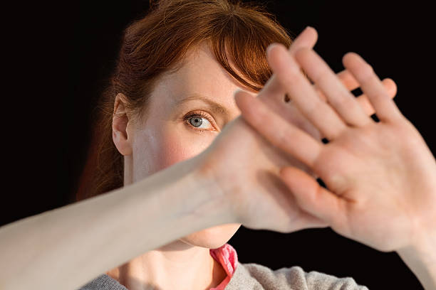 istock Scared woman covering her face 516079851