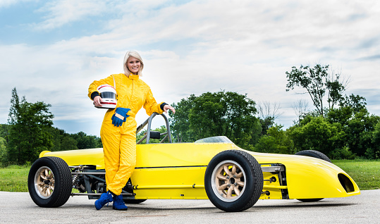 Female driver standing with a 1977 