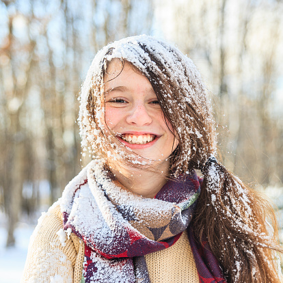 funny teenager girl portrait with the snow on the hair. Winter, outdoor, daylight. 