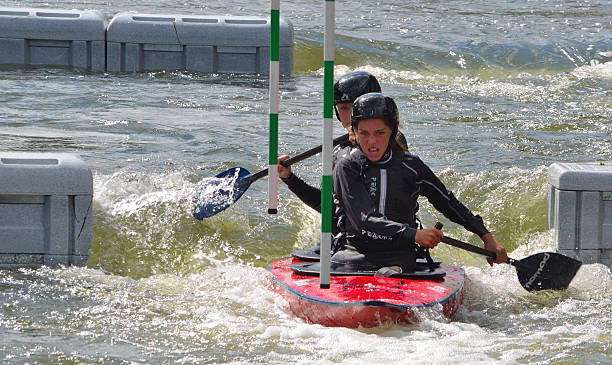 Ladies Double Canoe Bedford, Bedfordshire, England - August 31, 2014: Ladies Doubles Competitosr in competition at Bedford Viking Kayak Club Cardington Slalom Course. ouse river photos stock pictures, royalty-free photos & images