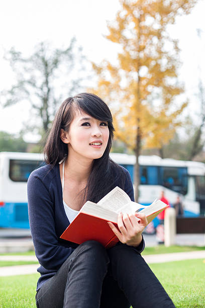 istock Young asian women with a  book 516083719