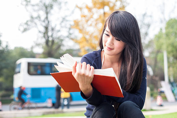istock Young asian women with a  book 516083931