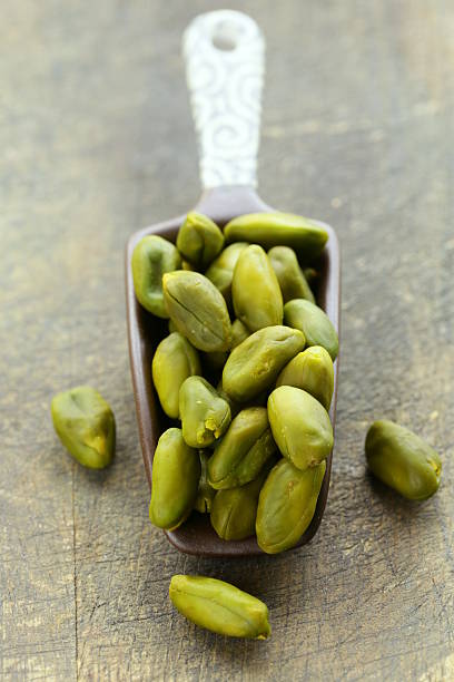 istock peeled green pistachio nuts on a wooden background 516084511