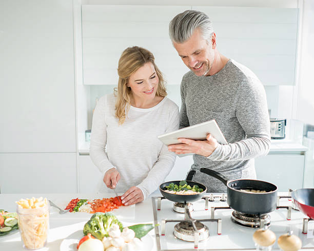 istock Couple cooking together at home 516098512