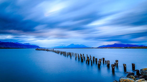Pier Puerto Natales Torres Del Paine This is a kind of wooden dock in the city of Puerto Natales. Close to the city center. Ideal for walking.  cuernos del paine stock pictures, royalty-free photos & images