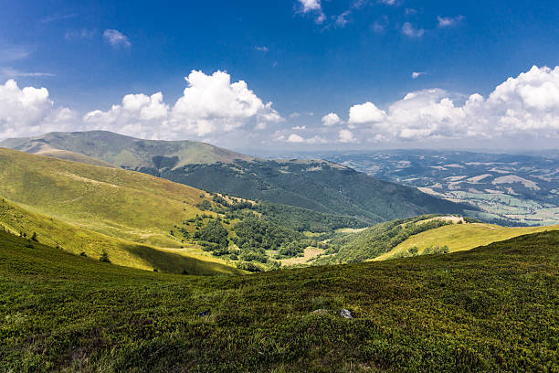 istock Road on grass on the hill on mountain background 516100190