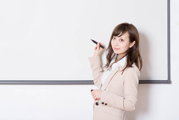 istock Japanese woman having a seminar in a class room 516101544