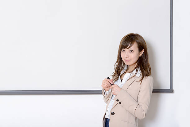 istock Japanese woman having a seminar in a class room 516101580