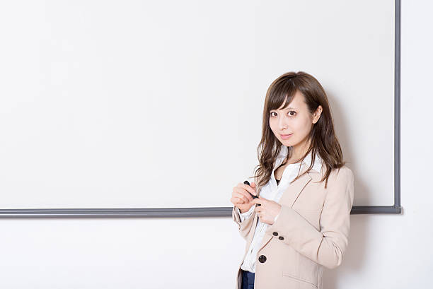 istock Japanese woman having a seminar in a class room 516101614