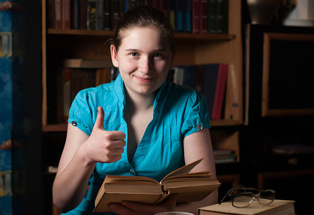 istock young girl in glasses reading a book 516101662