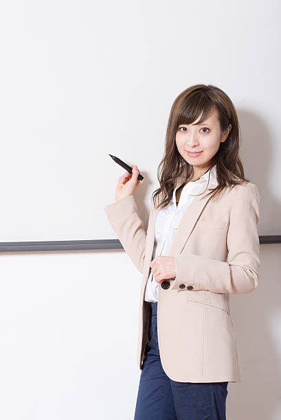 istock Japanese woman having a seminar in a class room 516101736