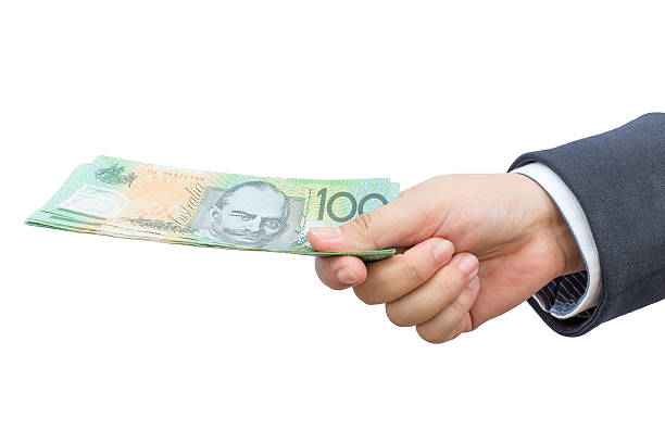 istock Businessman hand holding Australian dollars (AUD) bank note. 516101764