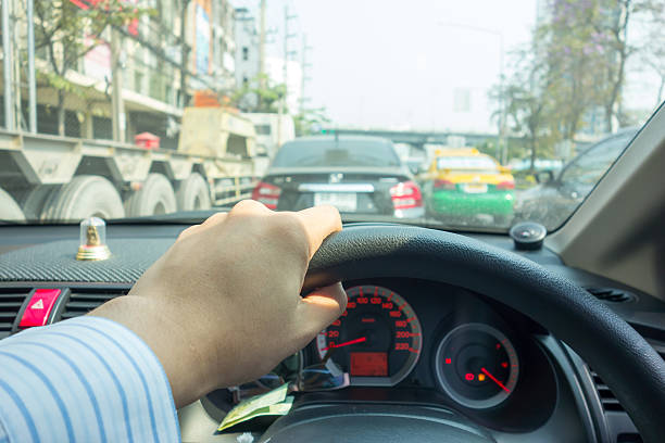istock The Man hand driving car on the traffic jam 516104058