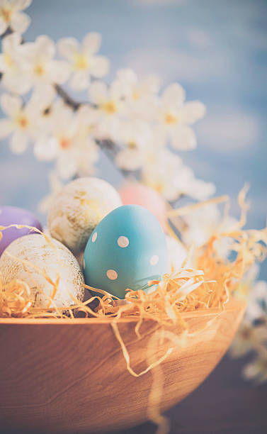 istock Easter arrangement with decorated eggs and blossoms 516104394