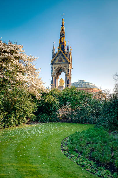 Prince Albert memorial seen from Kensington gardens Prince Albert memorial seen from Kensington gardens on a spring day with the cherry trees blossoming george vi stock pictures, royalty-free photos & images
