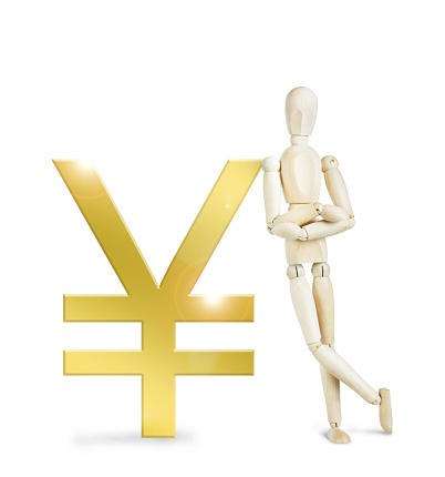 Man leaned against a huge golden Yen sign. Abstract image with a wooden puppet