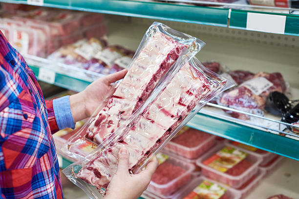 istock Woman chooses pork ribs in store 516110424