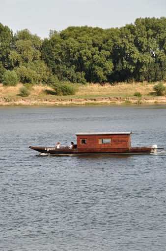 Bouchemaine, France - August 02, 2015: wooden boat on the Loire river at summer
