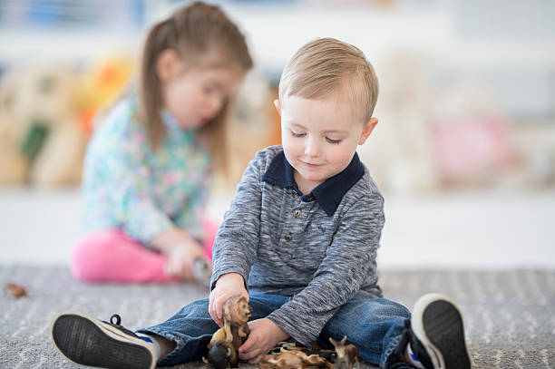 istock Cute Little Boy Playing with His Toys 516111718