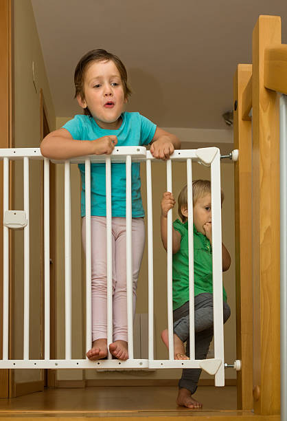 istock Two girls approaching safety gate of  stairs 516111945