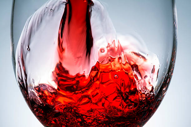 istock stream of wine being poured into a glass,  wine, splashing, splash 516111992