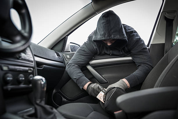 istock Thief in a mask hijacks the car 516112375
