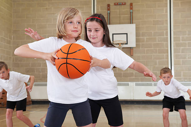 istock Elementary School Pupils Playing Basketball In Gym 516114685