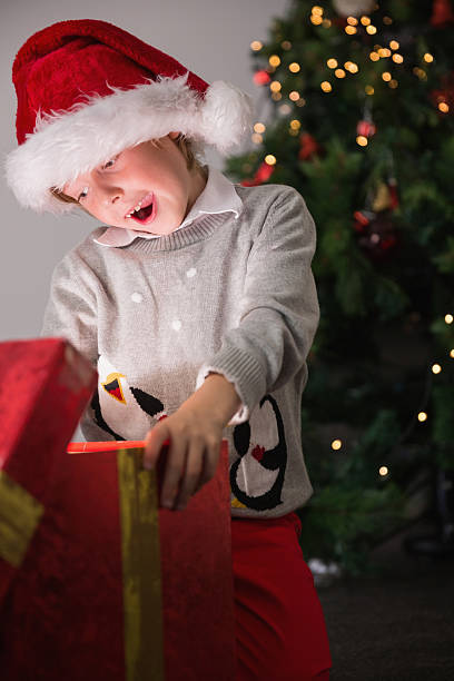 istock Child opening his christmas present 516116337