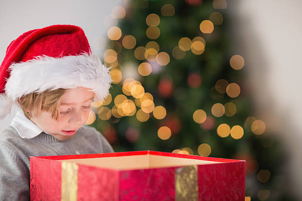 istock Child opening his christmas present 516116353