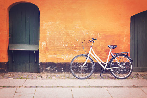 istock City bycicle leaning on the brick wall 516116889