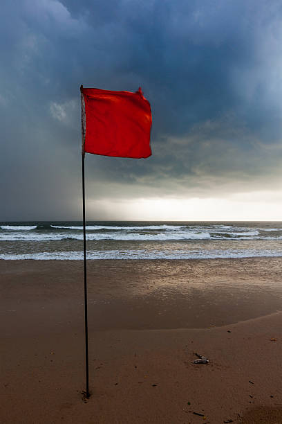 istock Storm warning flags on beach. Baga, Goa, India 516118207
