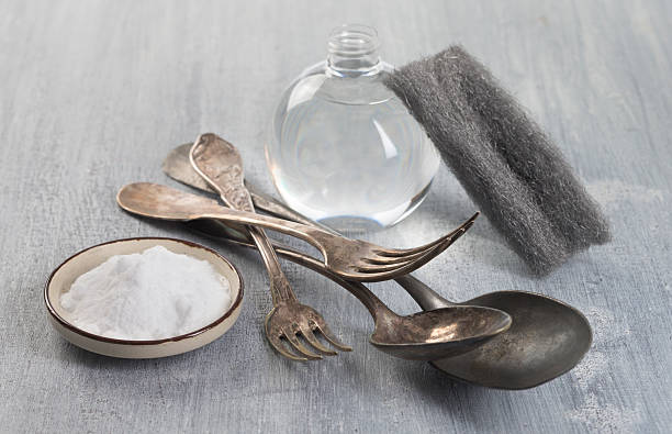Cleaning Vintage silverware with bicarbonate and vinegar stock photo