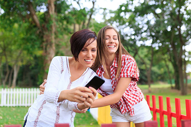 istock Happy girls making selfie with phone 516134394