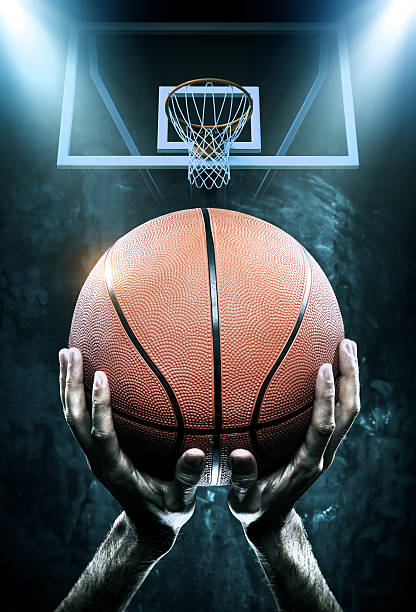 Basketball arena with player Close-up of basketball player with a ball scoreboard stadium sport seat stock pictures, royalty-free photos & images
