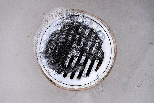 Hair clump in bath drain while taking a shower.