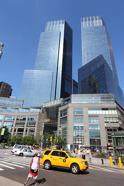 Columbus Circle NY New York, United States - July 6, 2013: Taxi drives at Columbus Circle in New York. Columbus Circle with famous Time Warner Center skyscrapers completed in 2003 is one of New York landmarks. time warner center columbus circle pictures stock pictures, royalty-free photos & images