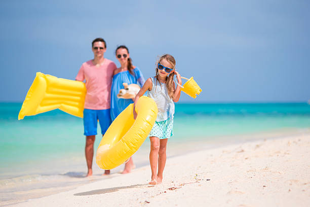 istock Young family on white beach during summer vacation 516135298