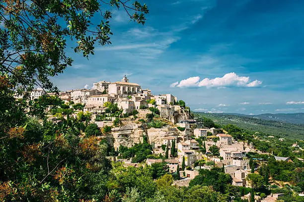 Beautiful scenic view of medieval hilltop village of Gordes in Provence, France. Blue sunny summer sky