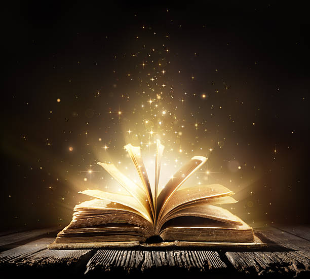 Magic Book With Shining Lights Aged book on wooden table fairy tale stock pictures, royalty-free photos & images