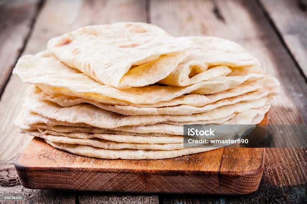 Stack of homemade wheat tortillas Stack of homemade wheat tortillas on wooden table Bread Stock Photo