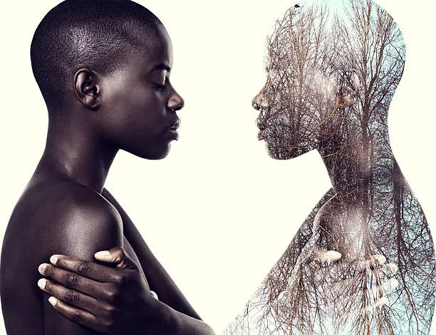 Multiple exposure shot of a young woman standing face to face with a mirror image of herself