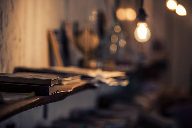 istock Abstract background with a lamp and book shelves 516140164