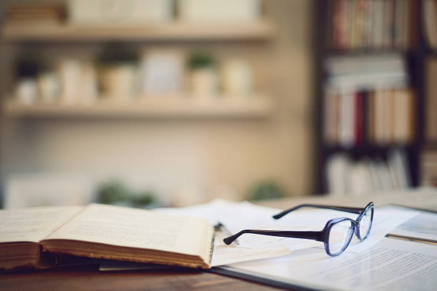 book and glasses on a table in home interior