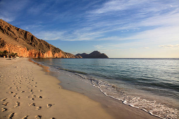Sunset, Zighy Bay, Dibba, Oman Footprints of sandy beach along the sea, quiet view on the sea and the surrounding mountains, Oman serin stock pictures, royalty-free photos & images